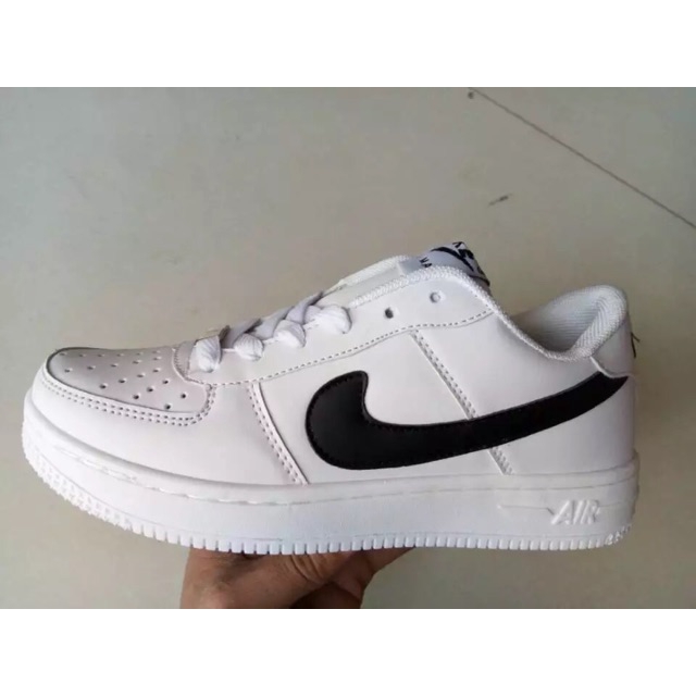 white nike trainers with gold tick