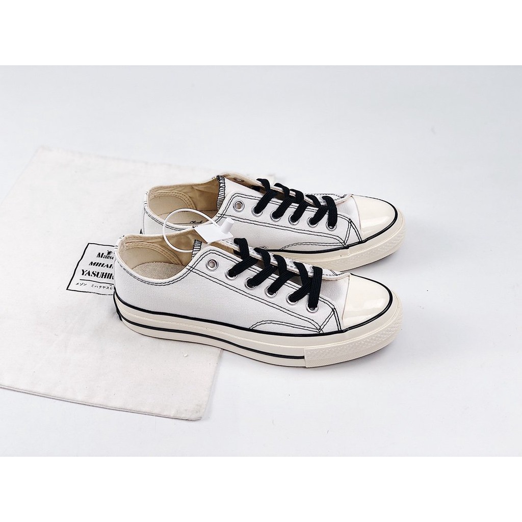 white converse with black line