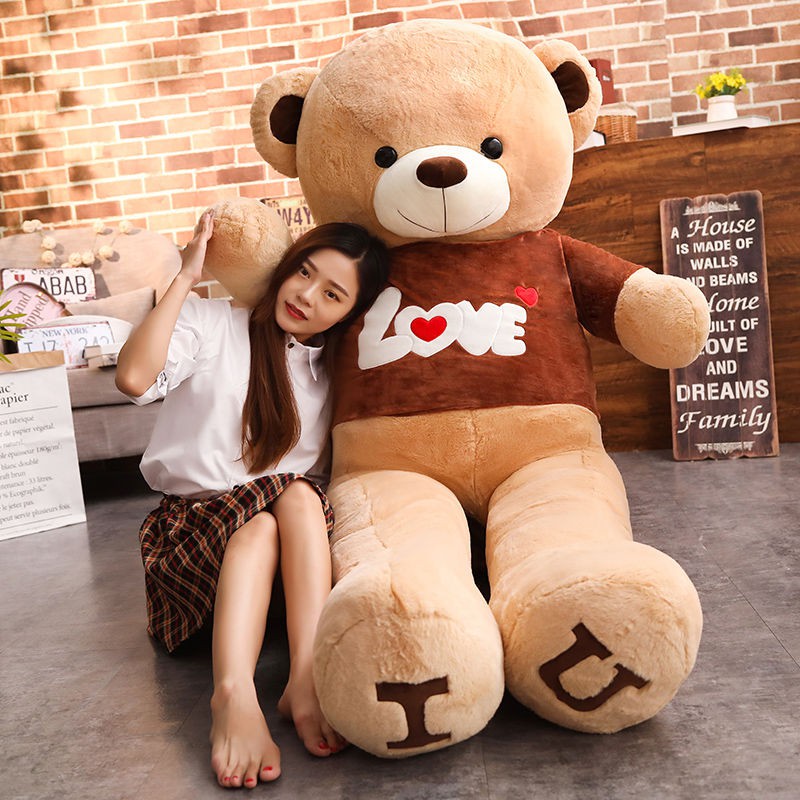 girl hugging giant teddy bear