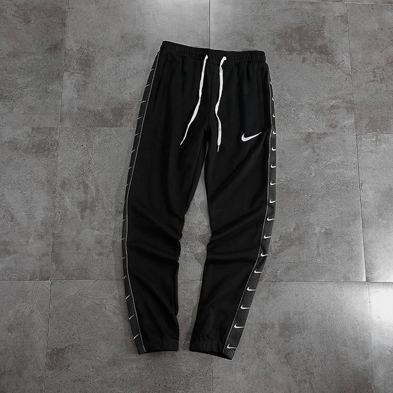 nike swoosh woven trousers