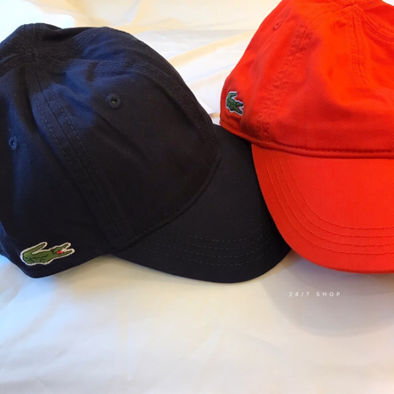 orange lacoste hat