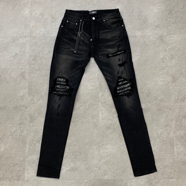 black amiri jeans with patches