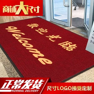 got a welcome mat on a big red door