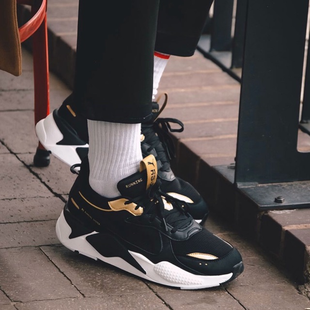 black and gold puma rsx