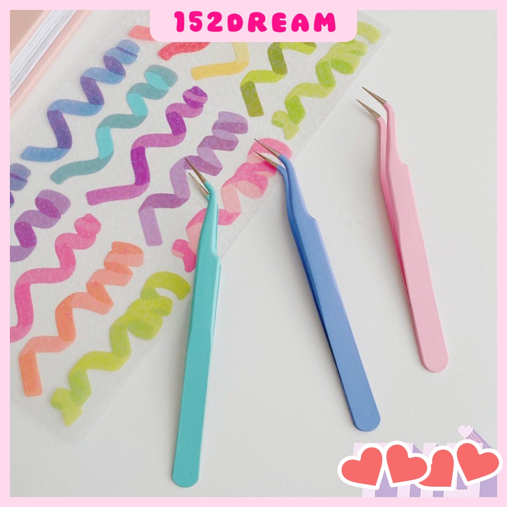 Tweezers for picking up washi stickers to help decorate notebook albums