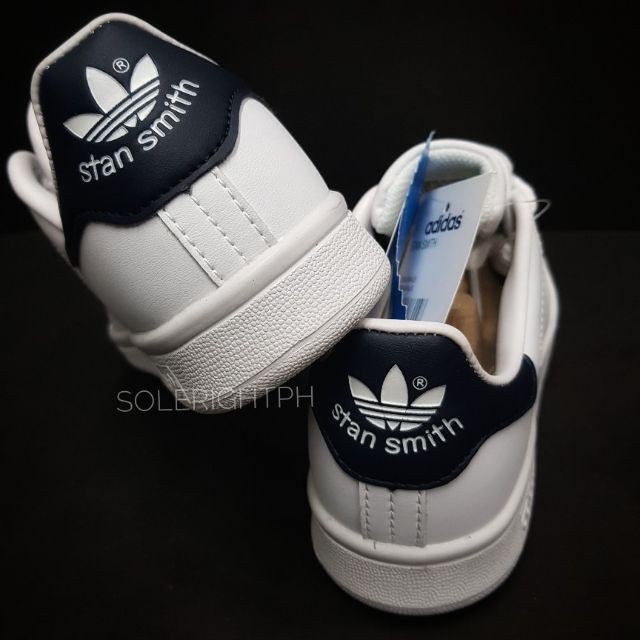 white and navy blue stan smiths
