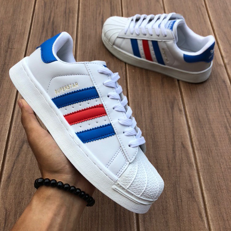 white adidas shoes with blue stripes