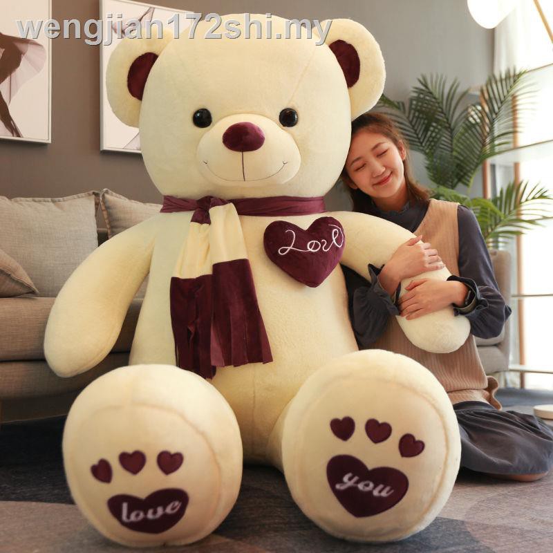 girl hugging giant teddy bear
