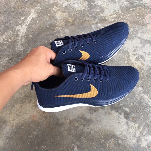 navy blue and gold nike shoes
