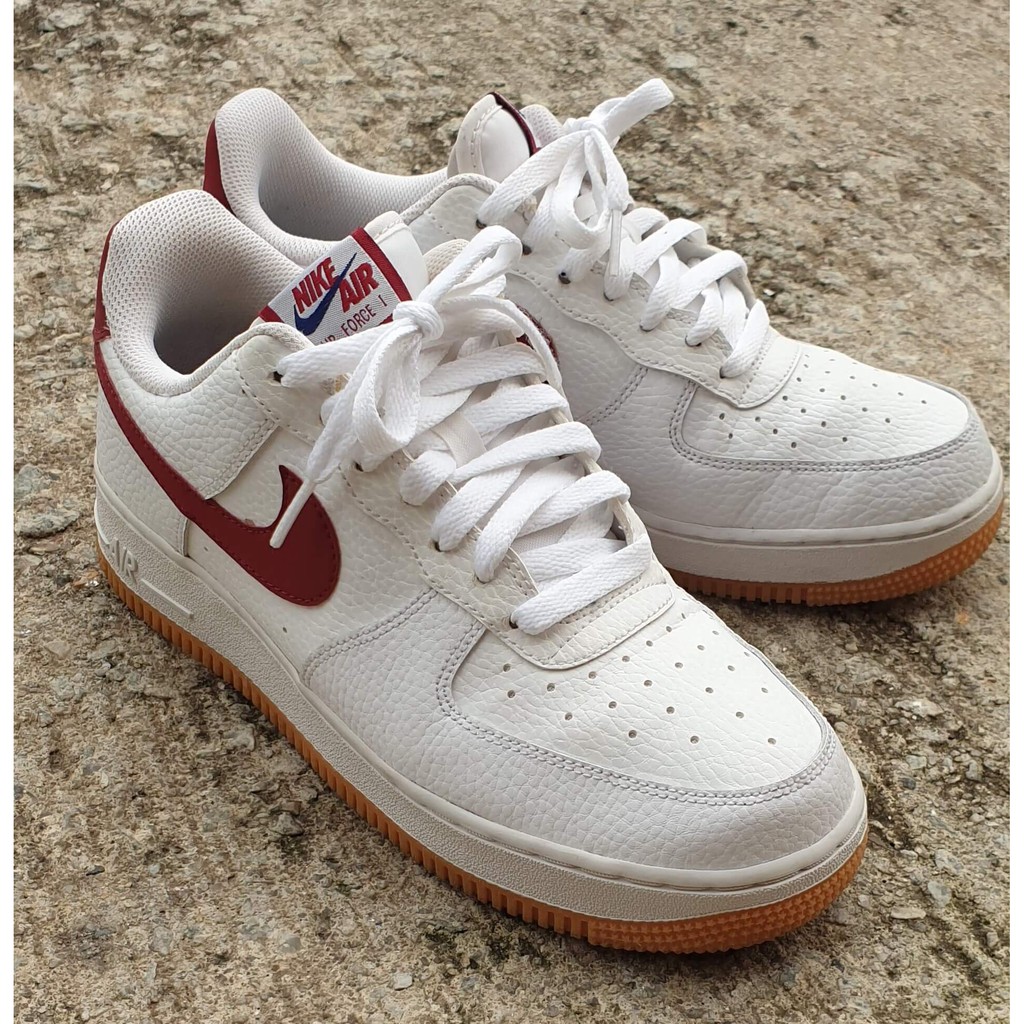 nike air force 1 trainers with red swoosh and gum sole
