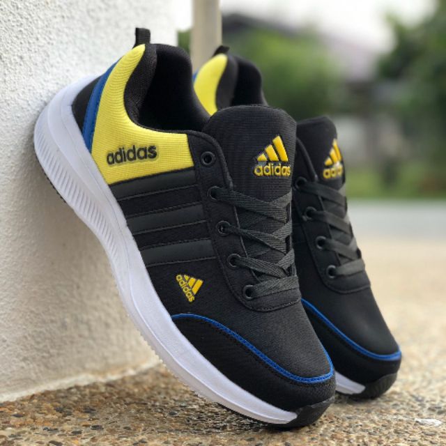 black and yellow athletic shoes