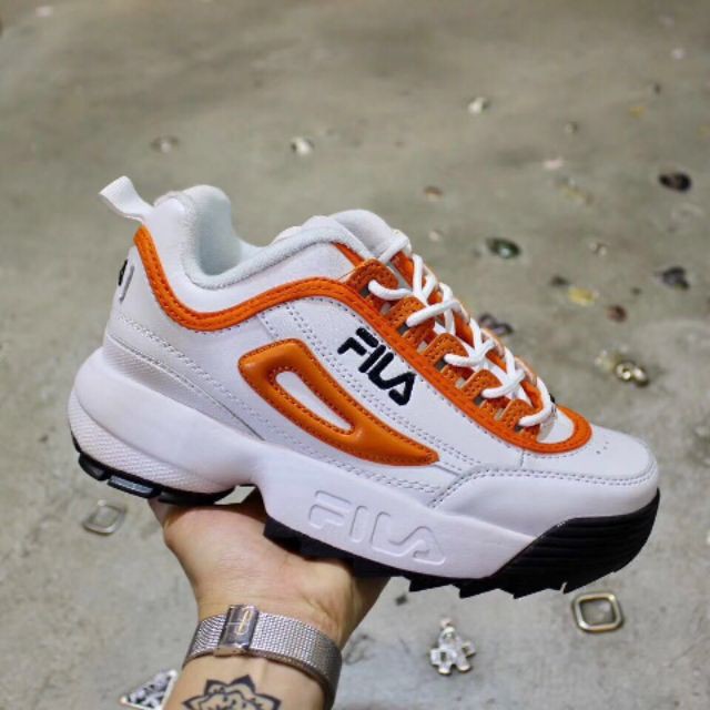 orange and white fila shoes