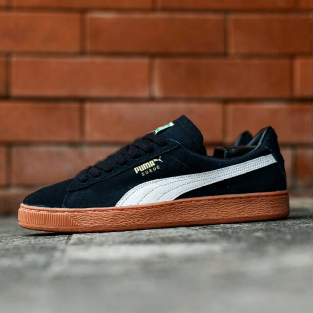black and white pumas with gum sole