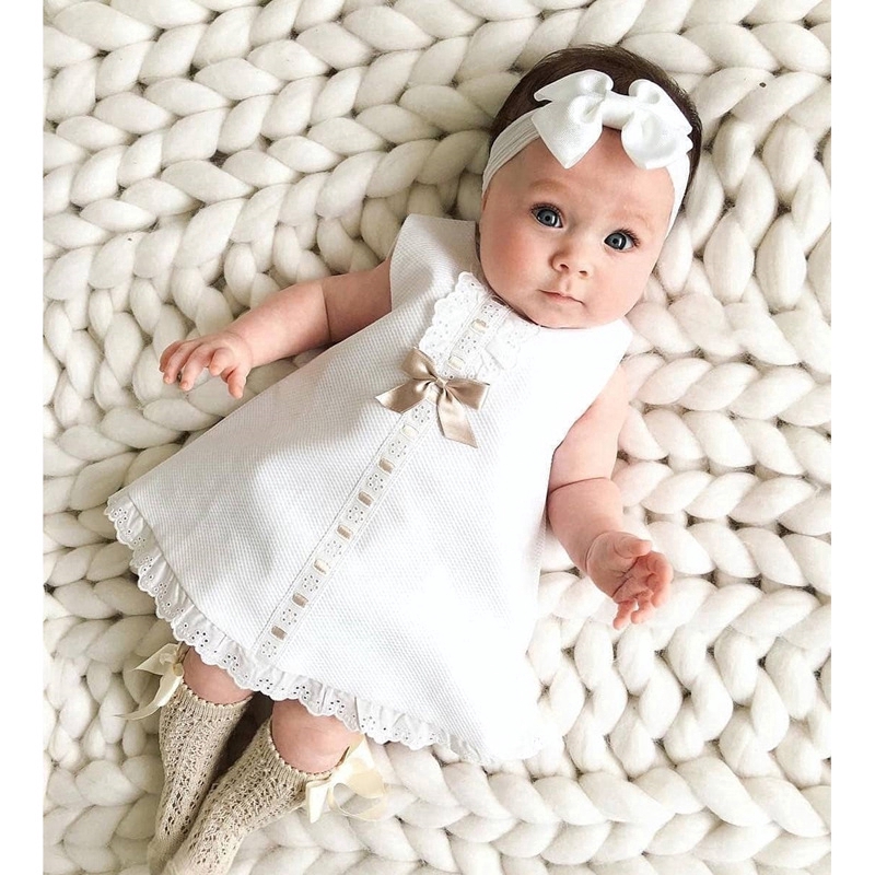 baby girl with white dress