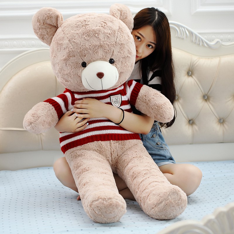 girl cuddling with giant teddy bear