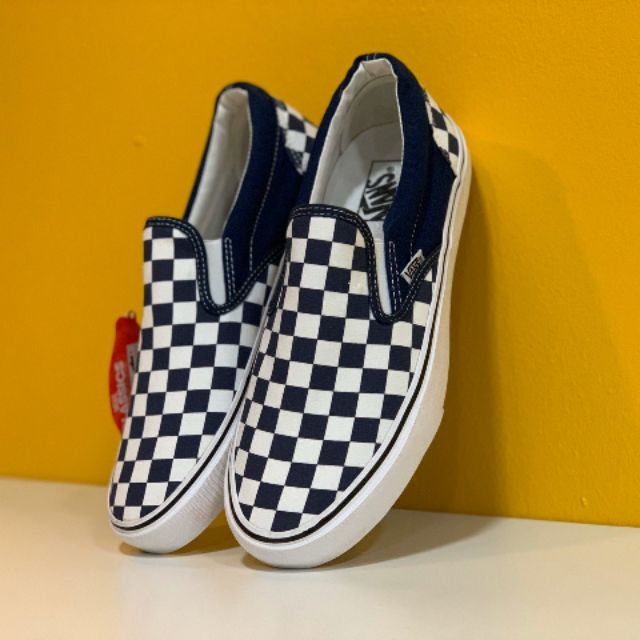 dark blue checkerboard slip on vans