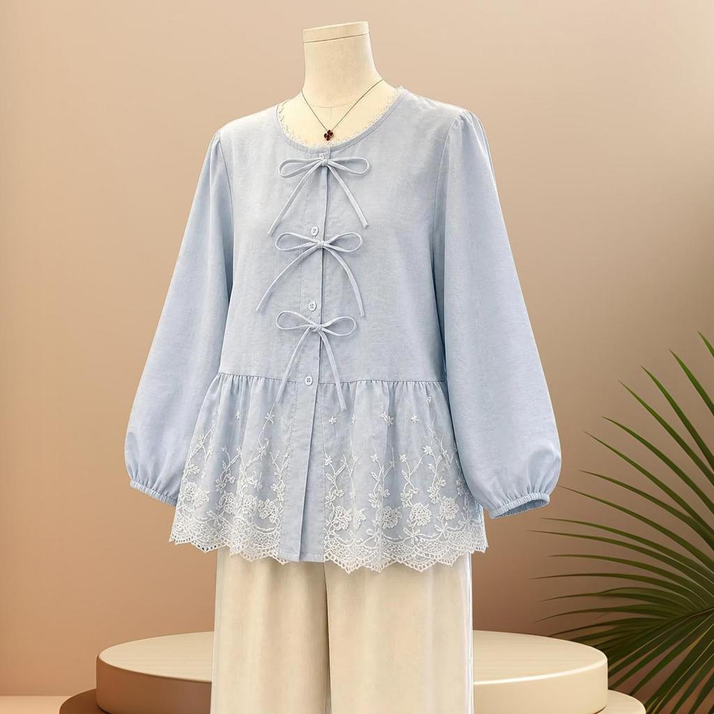 New women's dress in light blue with a round neckline, lace trim, waist belt, skirt cut, and ruffled sleeves in a soft style.